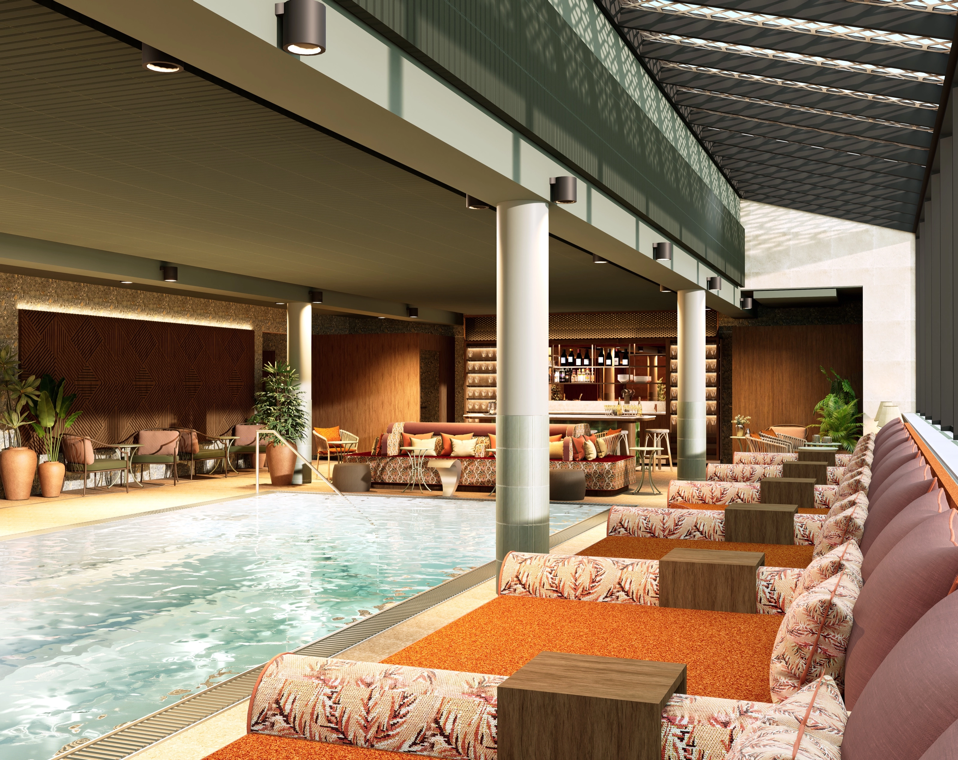 Indoor spa pool framed by lounge seating in leaf-patterned upholstery, a row of columns, and a bar at the far end.