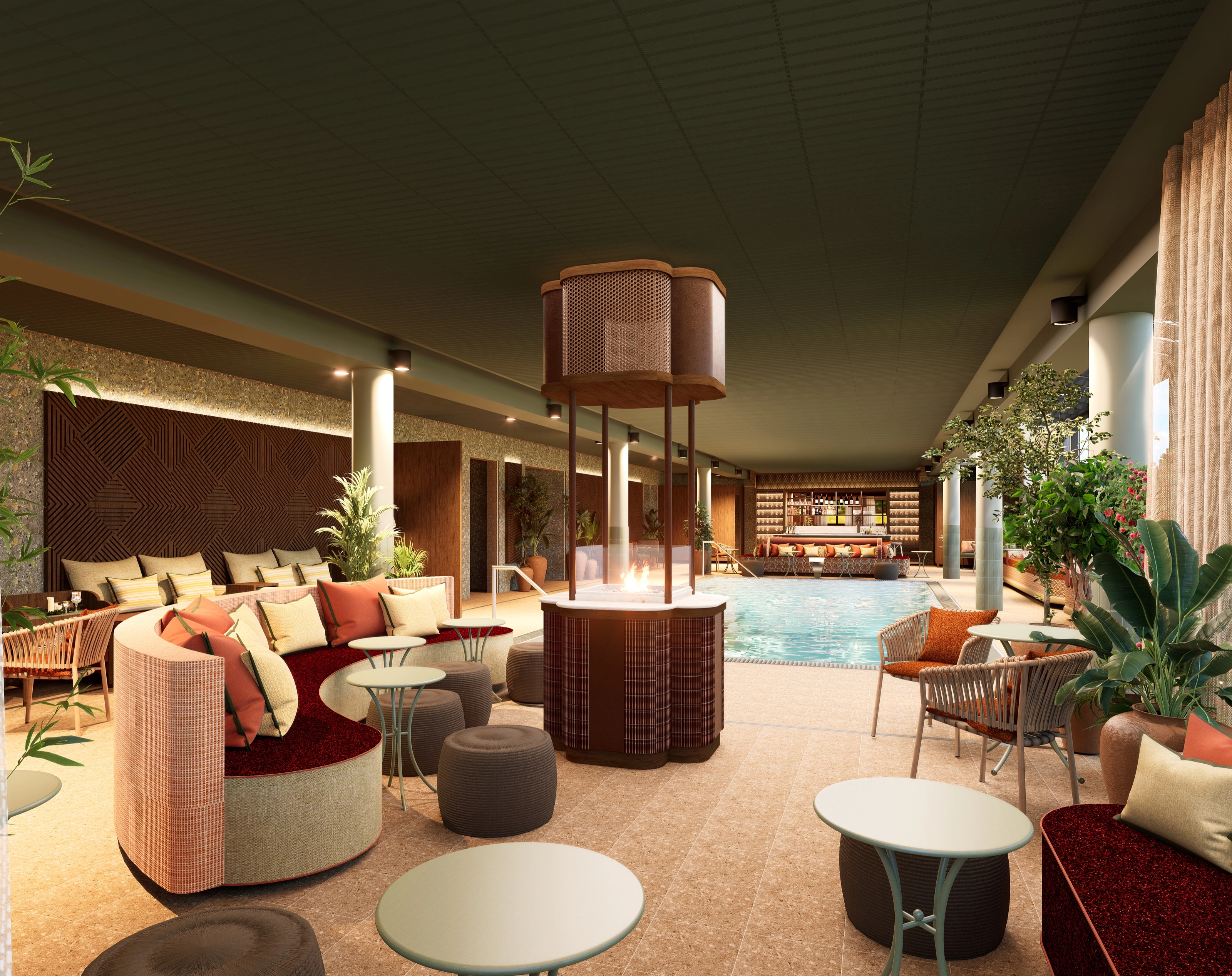 Lounge area with round sofas around a column-mounted fire feature, the spa pool behind.
