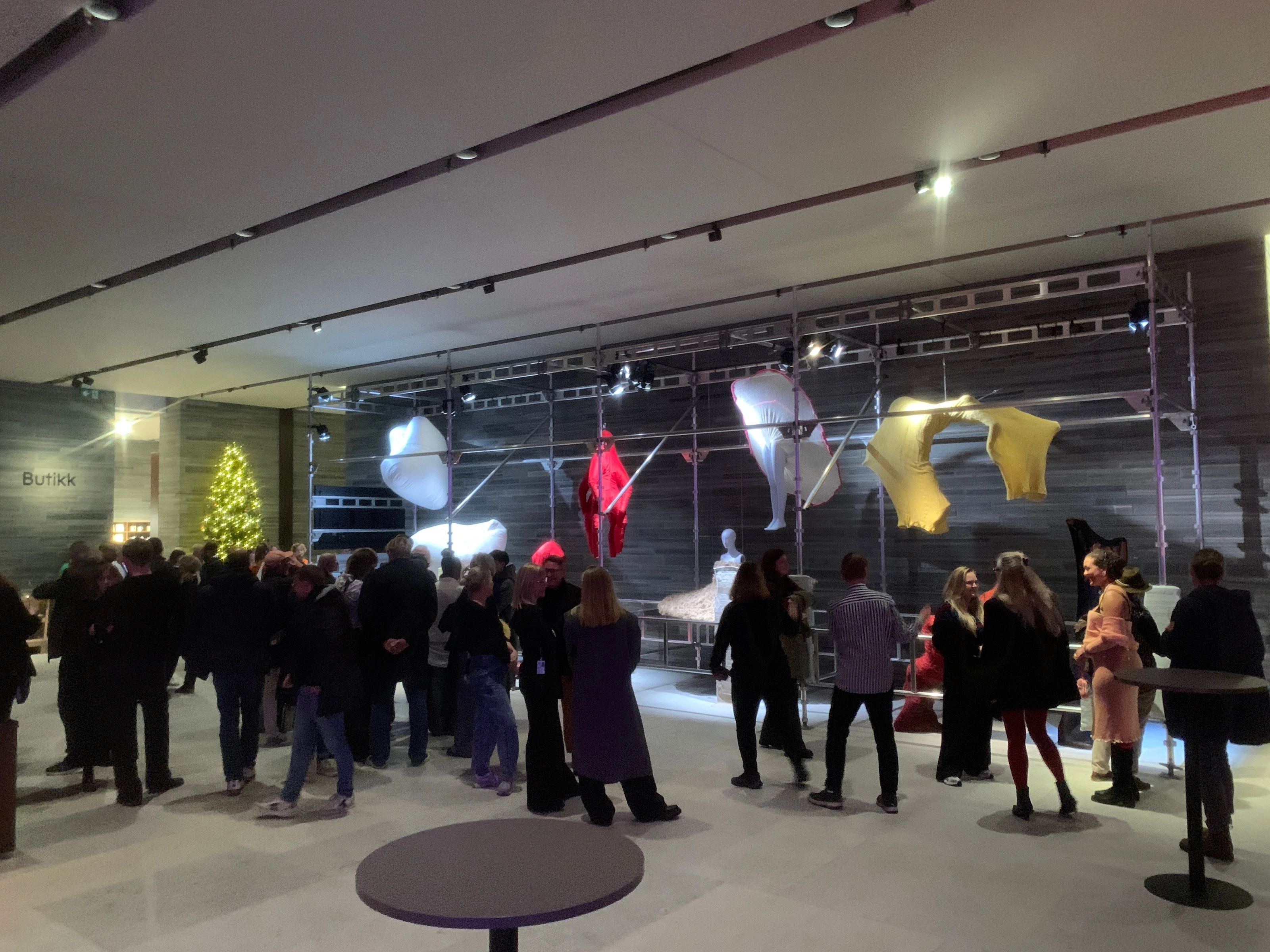 Photograph from the opening night with visitors gathered in front of the finished exhibition.